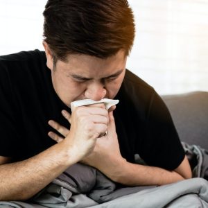Asian people are sick or ill with bronchitis while coughing