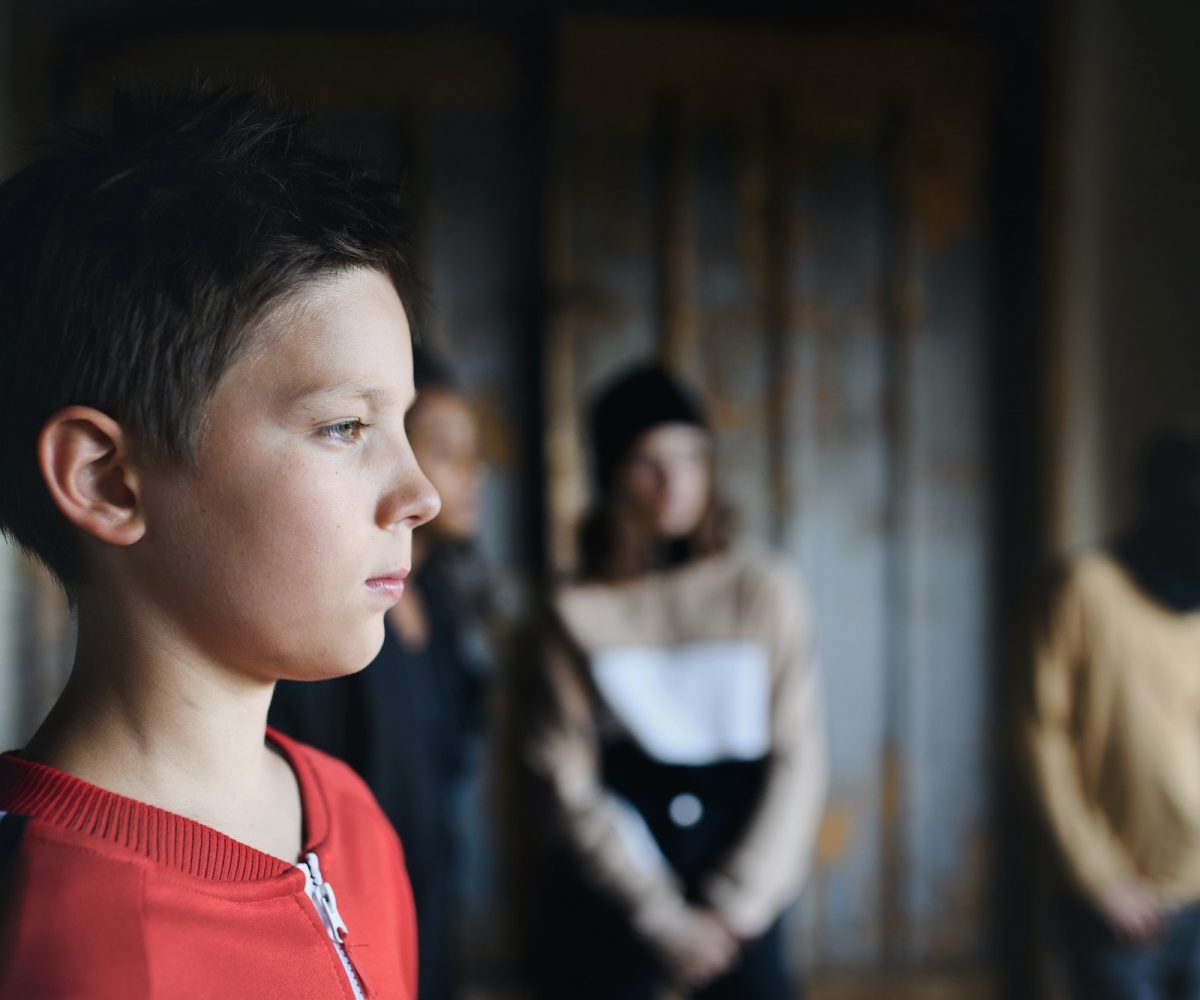 Sad and disappointed teenagers boy indoors in abandoned building, bullying concept.