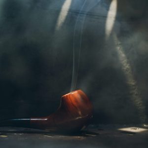 Smoking pipe on steel background with smoke. Smoking pipe on steel background with smoke.