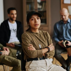 Young stressed Hispanic woman with her arms crossed on chest looking at you